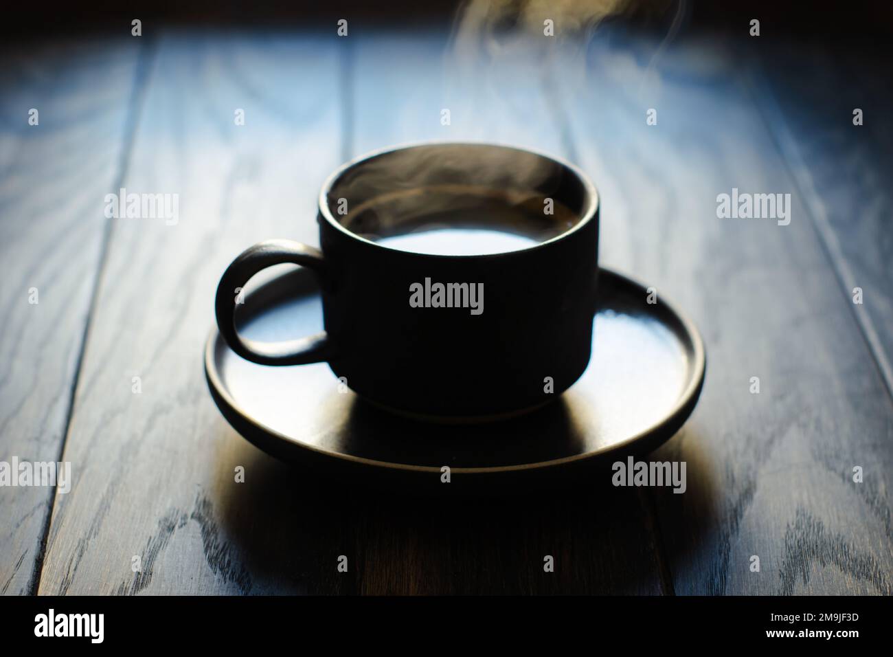 Coffee cup silhouette in back lit, soft focus close-up Stock Photo