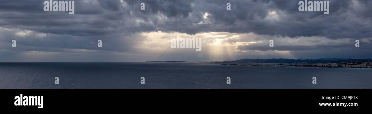 Dramatic Cloudy Sky with Sunrays on the Coast. Cloudscape Background Stock Photo