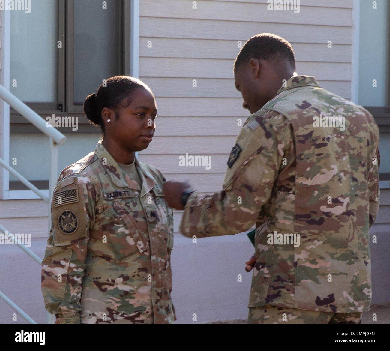 Army Staff Sgt. Karahn Bellamy pins the rank of sergeant on newly promoted Sgt. Kerry-Ann Barnett on May 19, 2022. Prior to her promotion, Staff Sgt. Bellamy recognized Barnett’s hard work and dedicated service to the Army, as well as for her dedication to the Special Operations Joint Task Force – Levant mission. Stock Photo