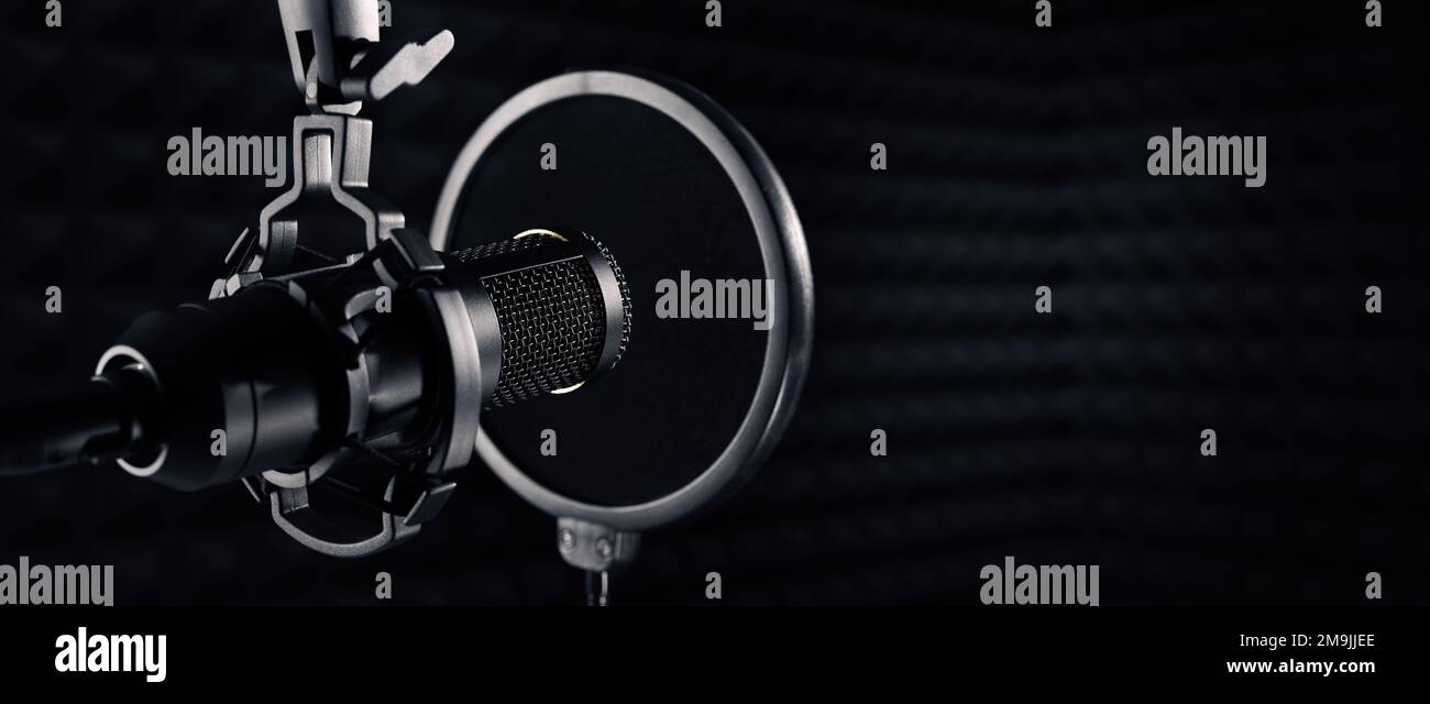 microphone in dark sound recording studio. banner with copy space Stock Photo