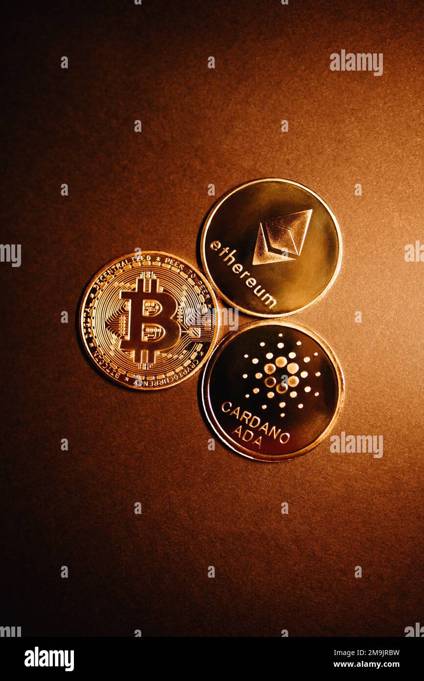 A vertical shot of an Ethereum, Bitcoin and Cardno Ada isolated on an  orange-to-black gradient background Stock Photo - Alamy