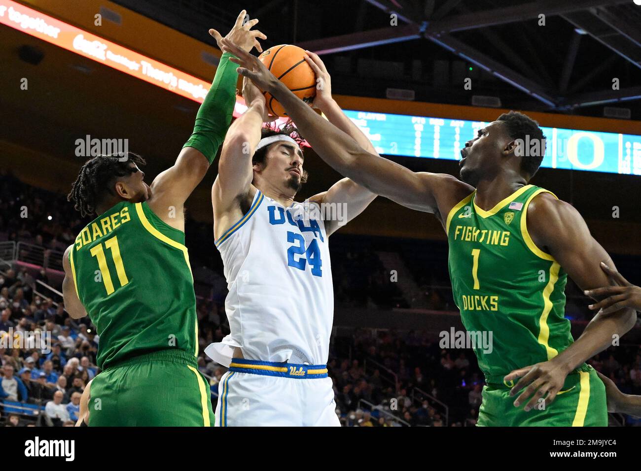 UCLA guard Jaime Jaquez Jr., center, takes the ball away from Oregon