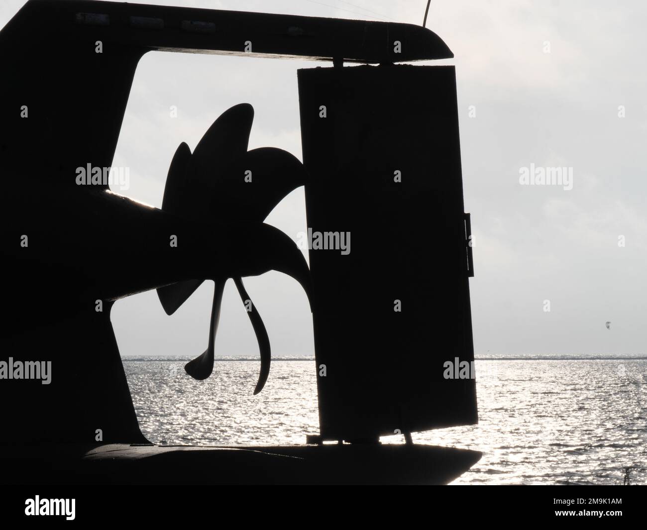 Rusty propeller of old submarine with rudder in back light Stock Photo