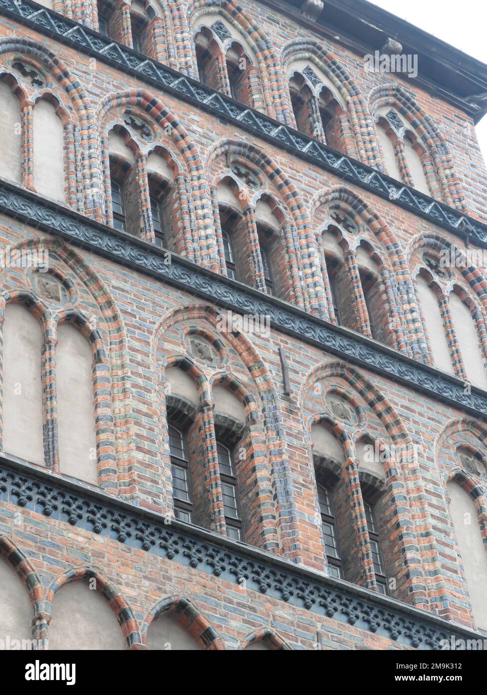 Gothic pointed arch windows on a clinker brick house in the city center of the Hanseatic city of Lübeck Germany Stock Photo