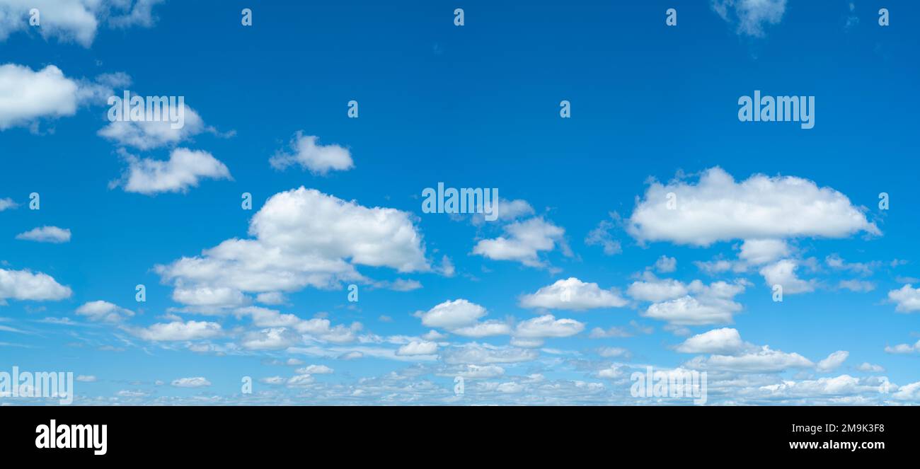 Cumulus clouds floating against blue sky Stock Photo