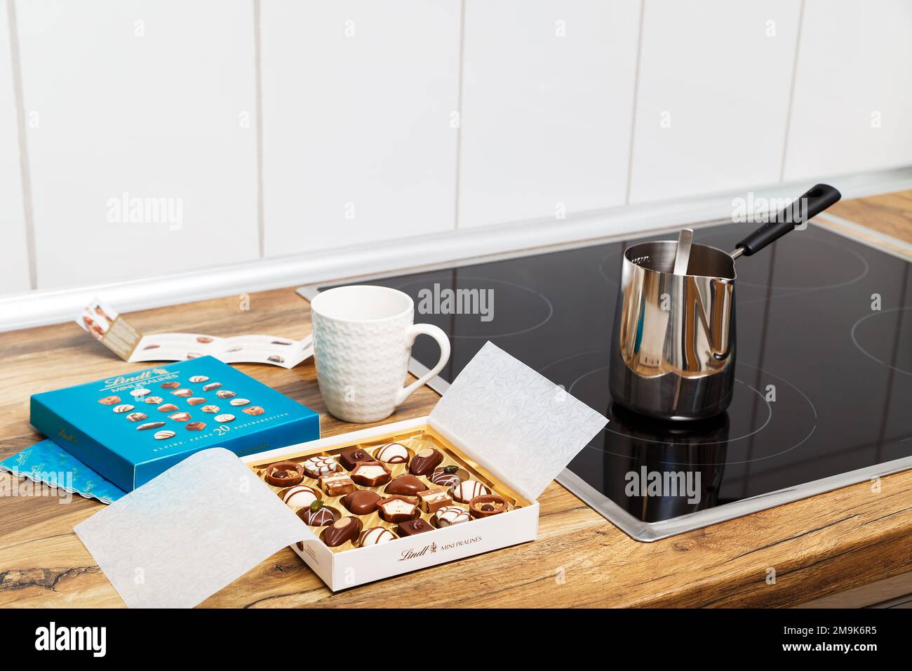 Zurich, Switzerland - January, 7 2023: Lindt Mini Pralines Box. Open small gift box of Swiss chocolate candies ready for coffee at kitchen. Luxurious selection of milk, dark and white sweets. Stock Photo