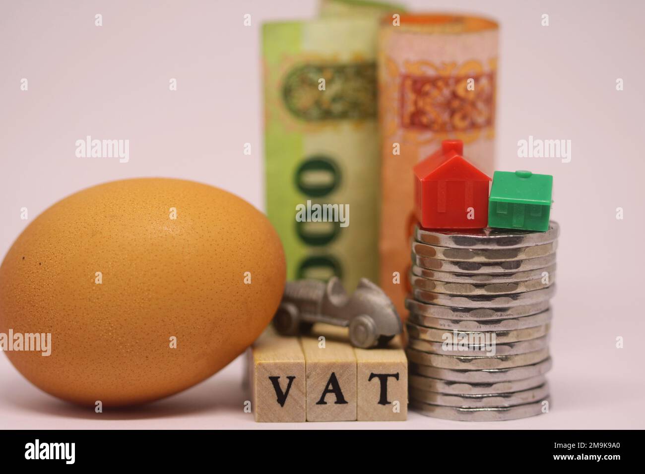 The wooden cube blocks with VAT text with Sri Lanka rupee coins, bills