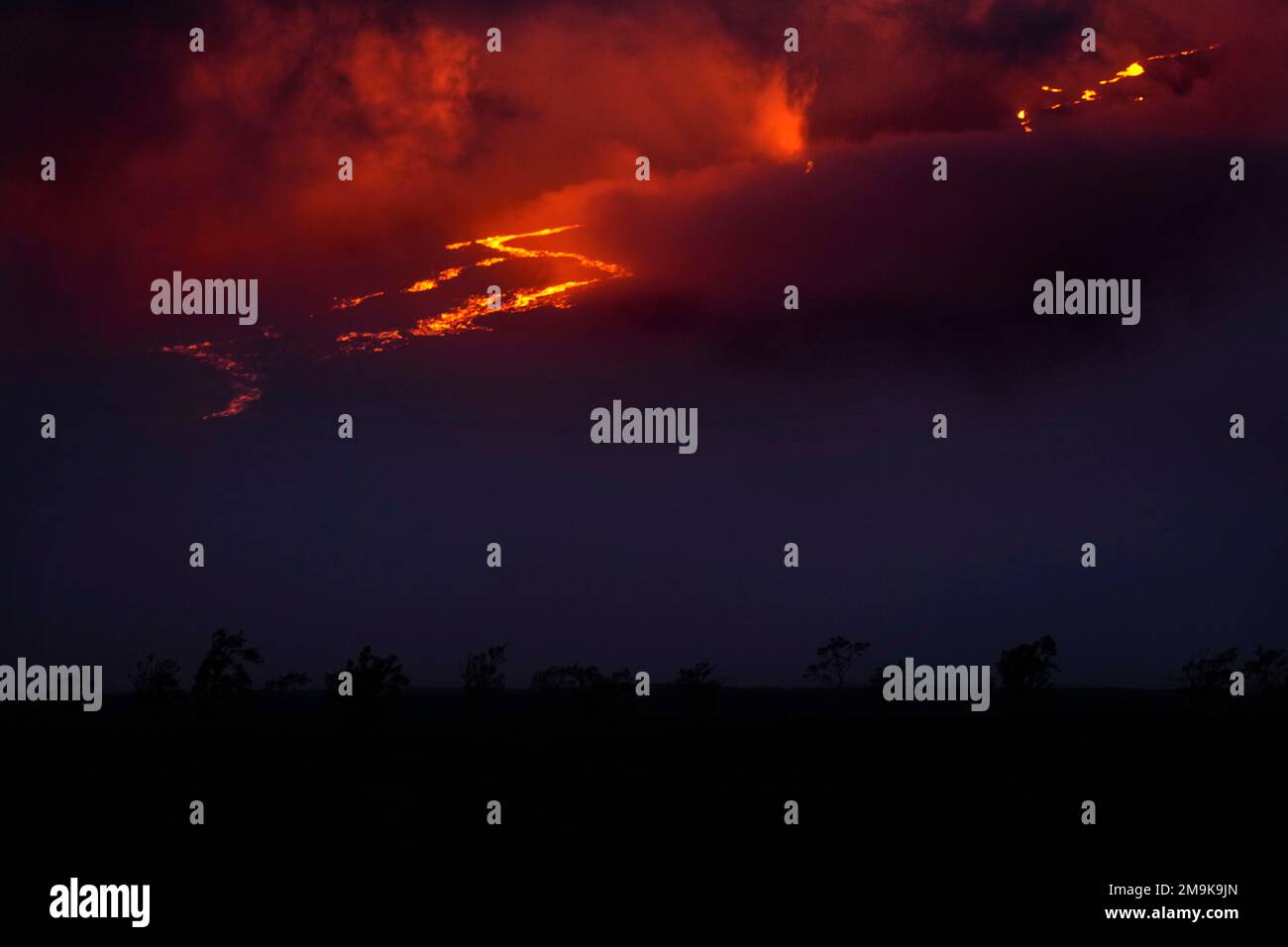 Lava flows through fissures as the Mauna Loa volcano erupts Saturday