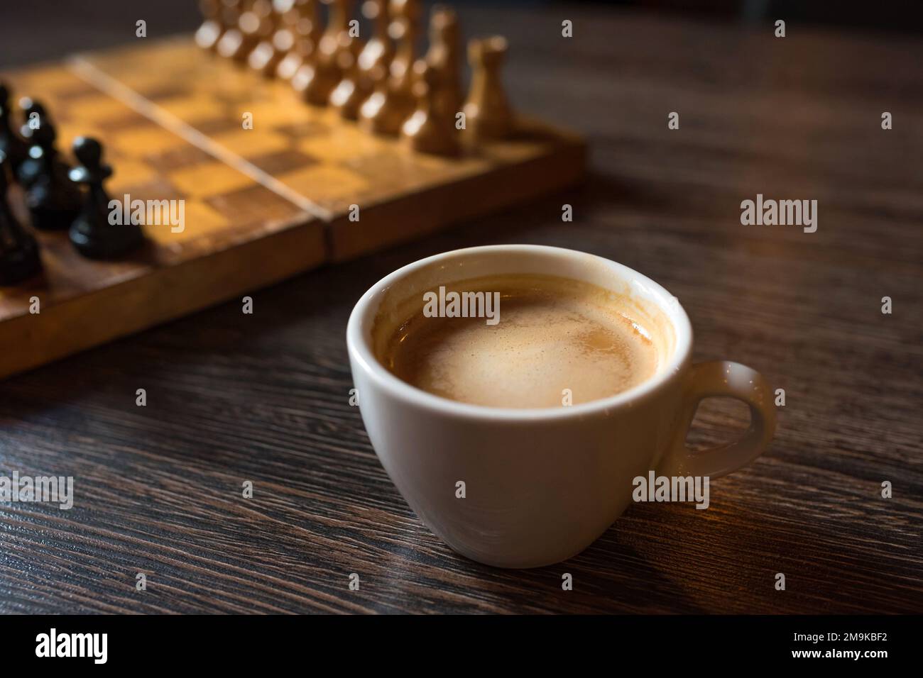 brown chess board with figures on a wooden table in a cafe, playing chess  Stock Photo - Alamy