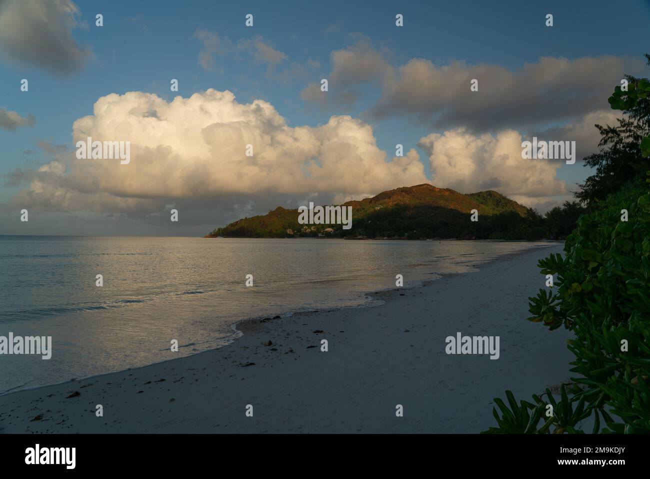 View along the long beach of Anse Volbert in the evening. Stock Photo