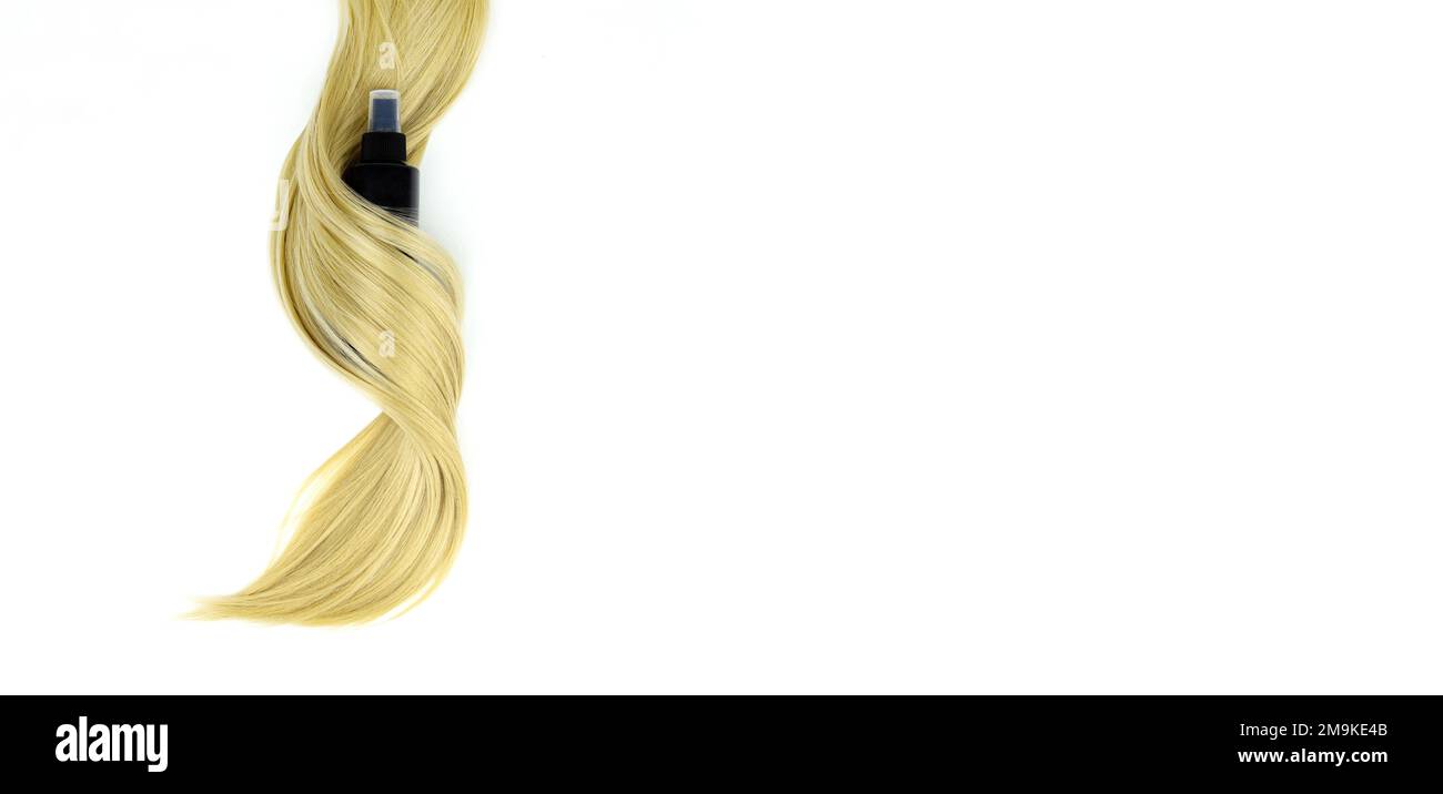 Different professional hairdresser tools hair spray and strand of blonde hair on white background, flat lay. Hair care spa concept Stock Photo