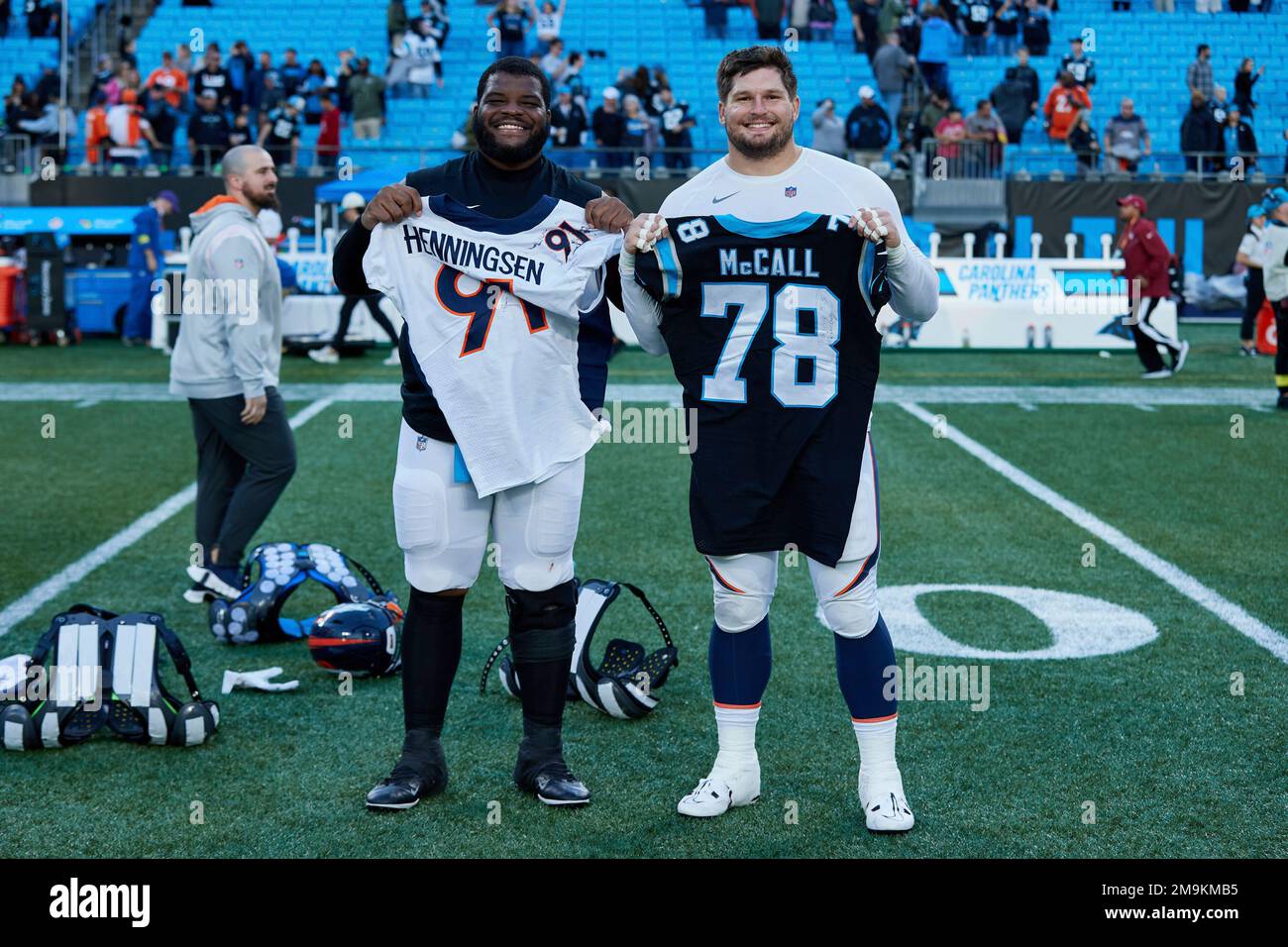 Carolina Panthers defensive tackle Marquan McCall (left) exchanges jerseys  with Denver Broncos defensive end Matt Henningsen (right) following an NFL  football game, Sunday, Nov. 27, 2022, in Charlotte, N.C. (AP Photo/Brian  Westerholt