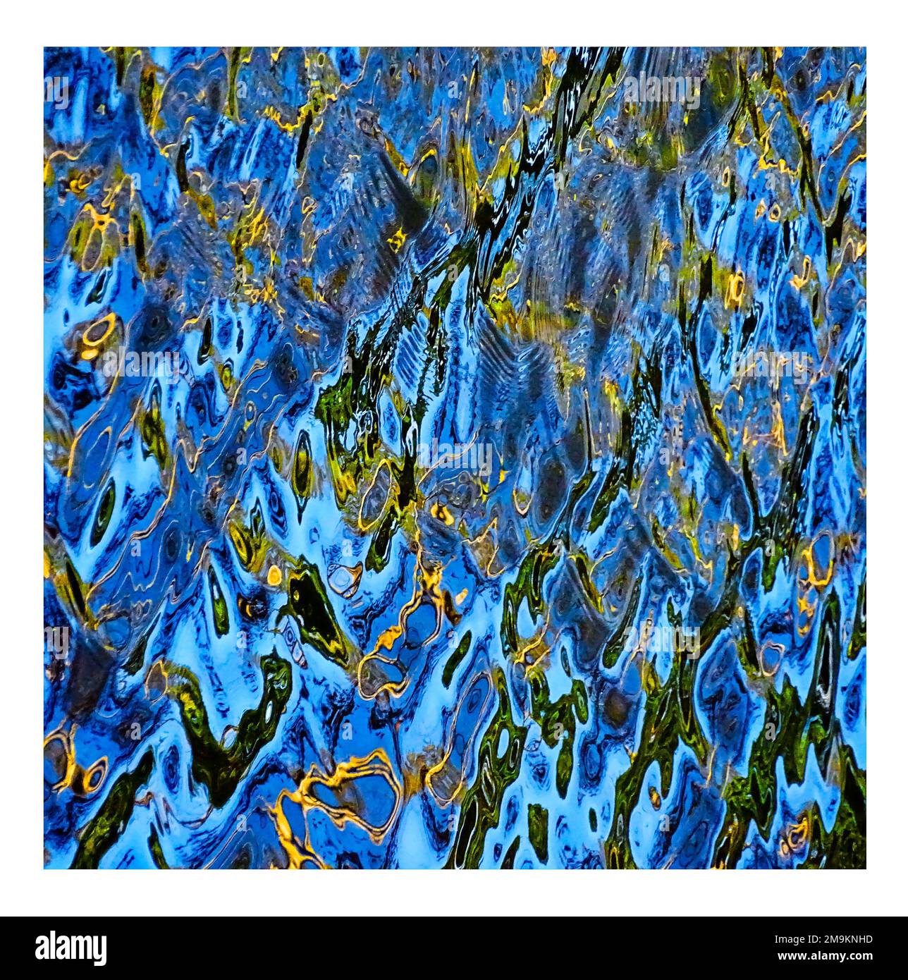 Abstract photograph of blue ripples and reflections in water Stock Photo