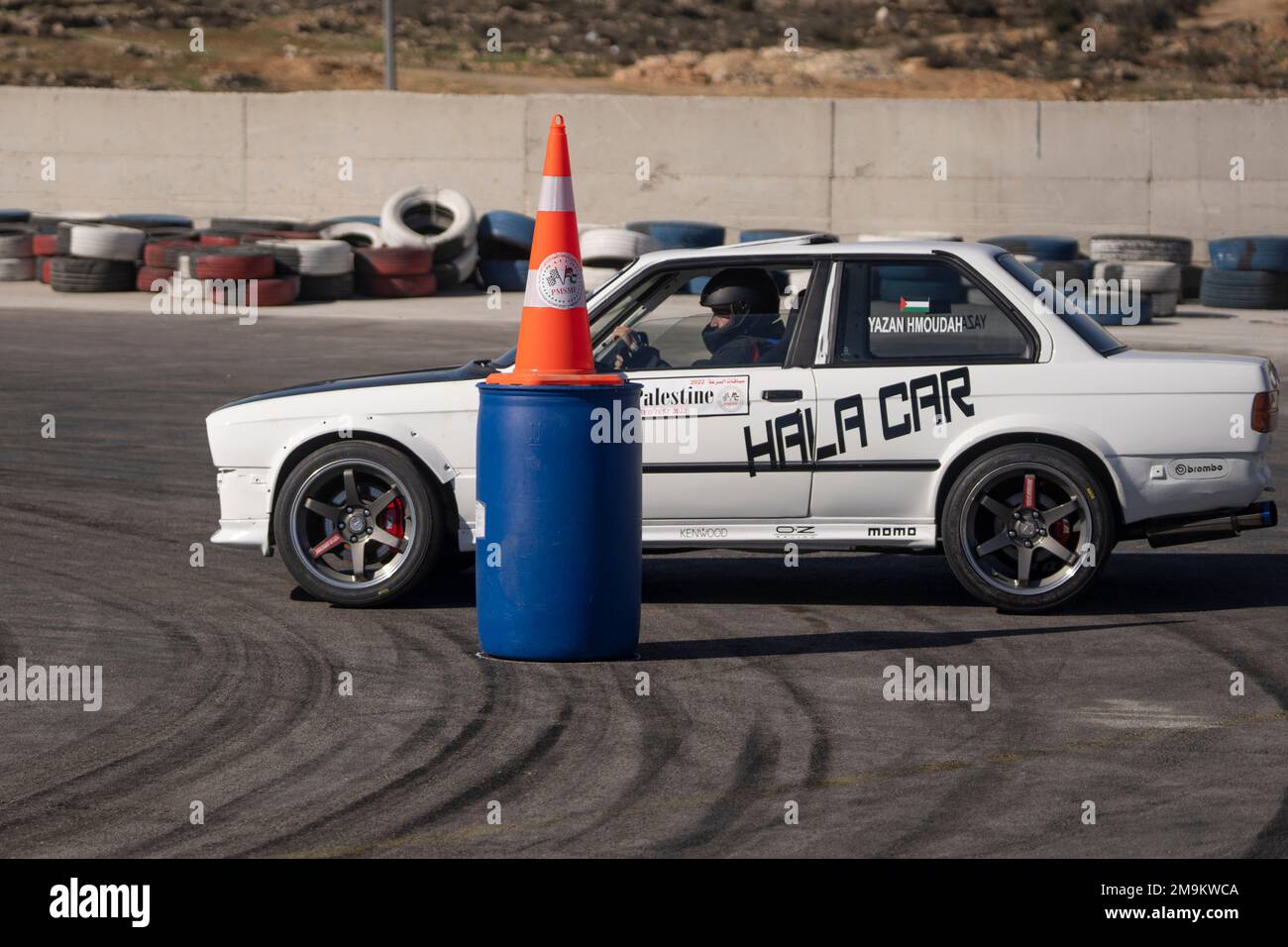 Palestinian Yazan Hamoudha rides in a race car during the fifth and final leg of Palestine Speed