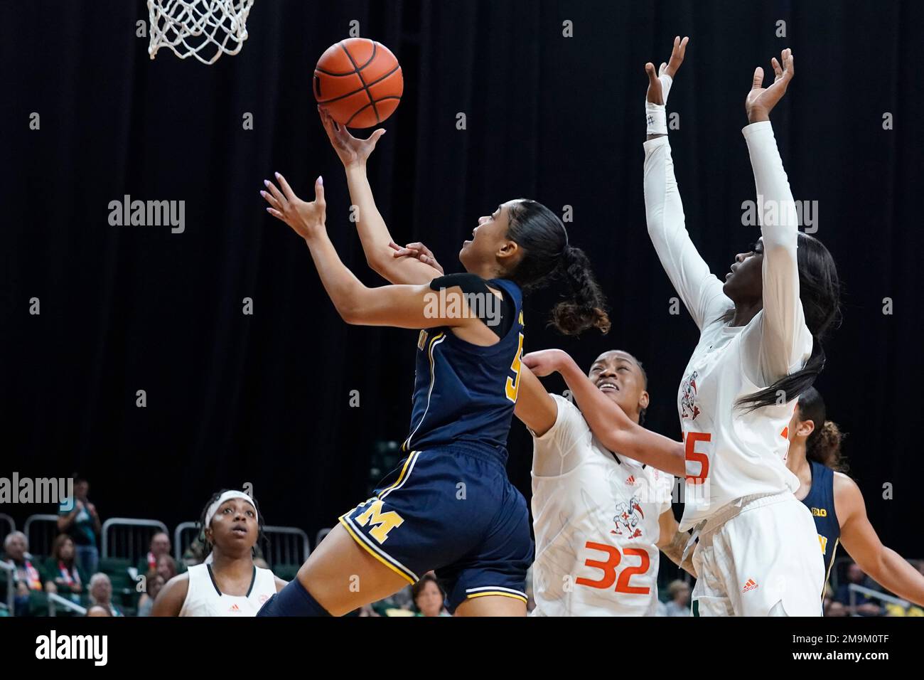 Michigan guard Laila Phelia (5) drives to the basket as Miami forward