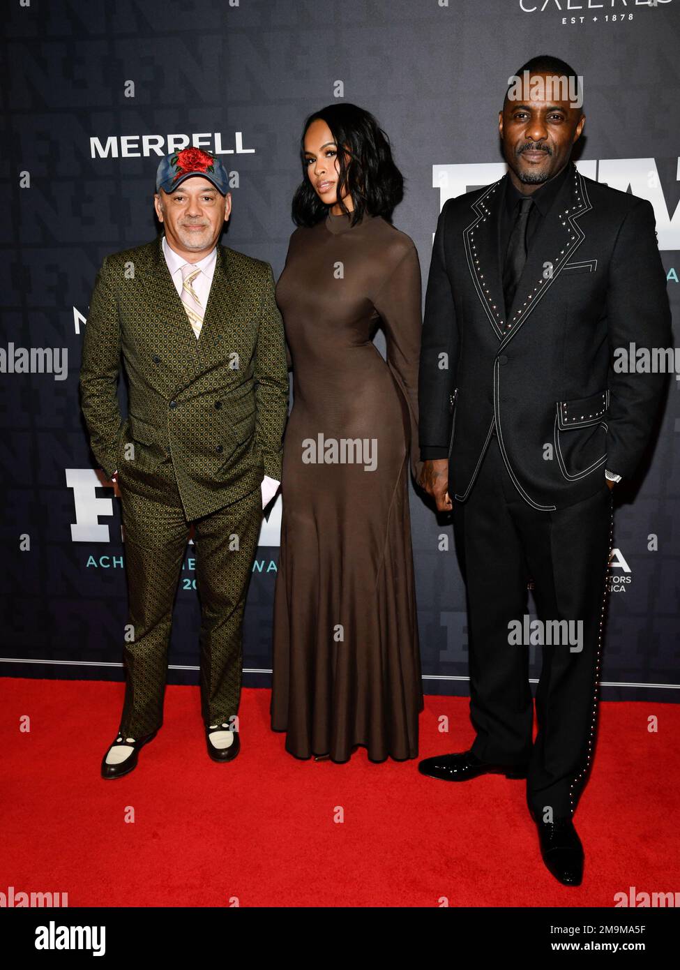 Lifetime achievement award honoree Christian Louboutin, left, Sabrina  Dhowre Elba and Idris Elba attend the 36th annual Footwear News Achievement  Awards at Cipriani South Street on Wednesday, Nov. 30, 2022, in New