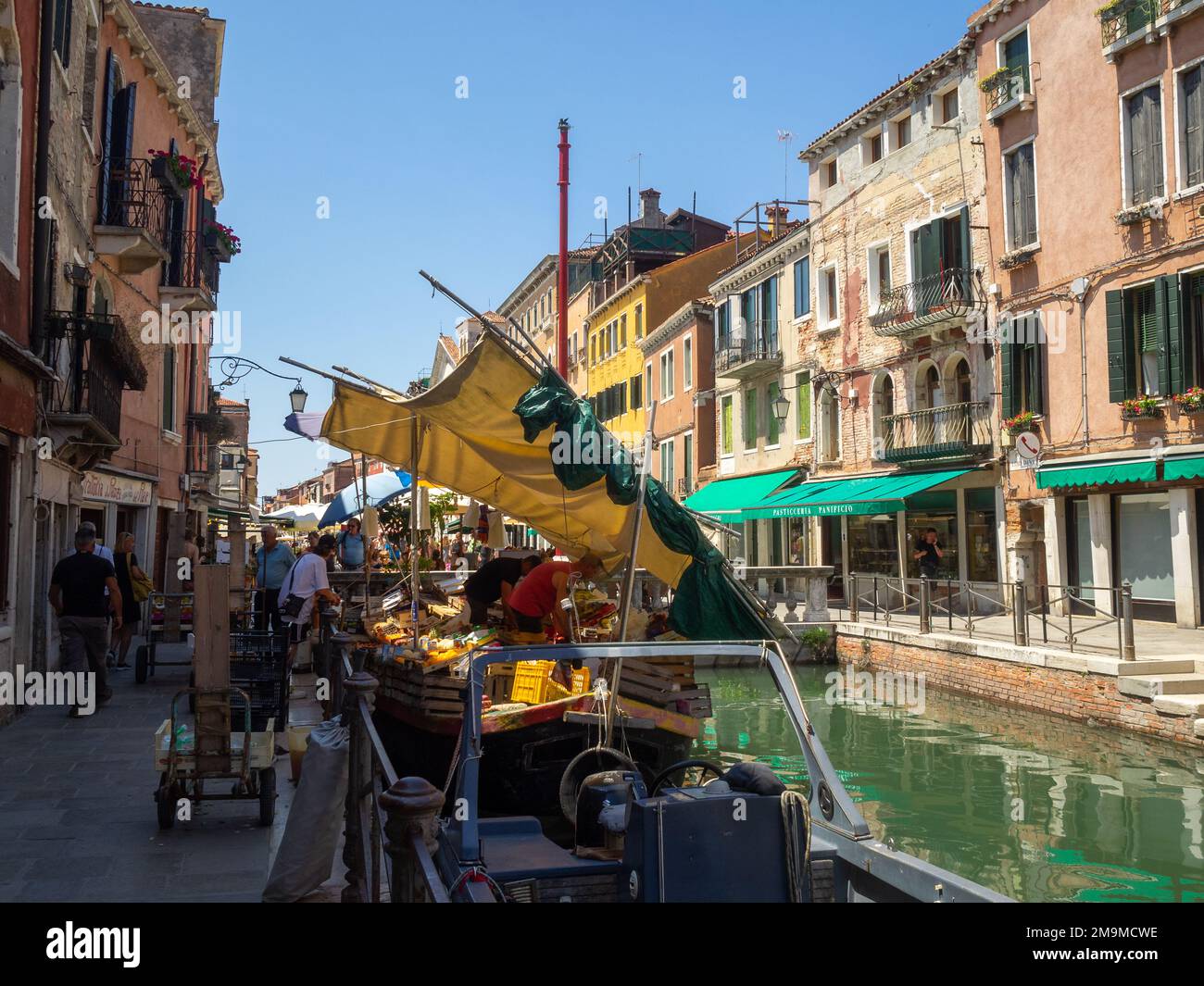 A fruits and vegetables shop in a boat on a canal in Castello, Venice Stock Photo