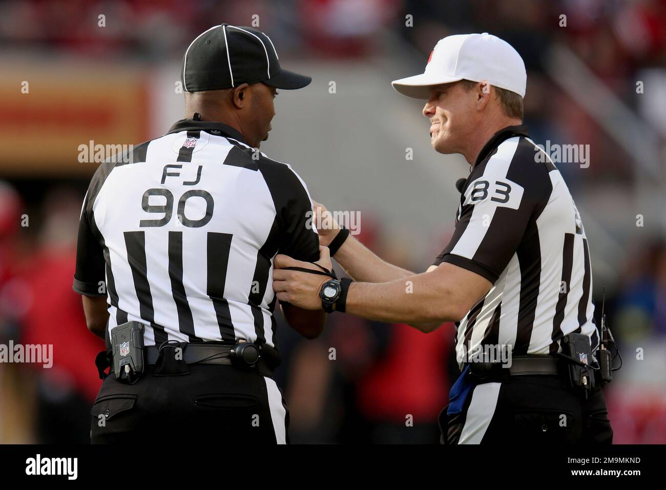 Referee Shawn Hochuli (83) and side judge Anthony Flemming (90