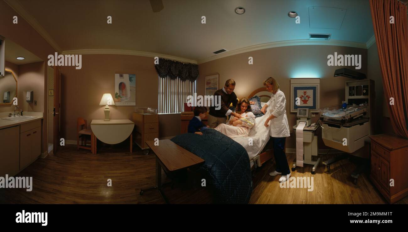 Interior of birthing room inside of hospital with family with newborn