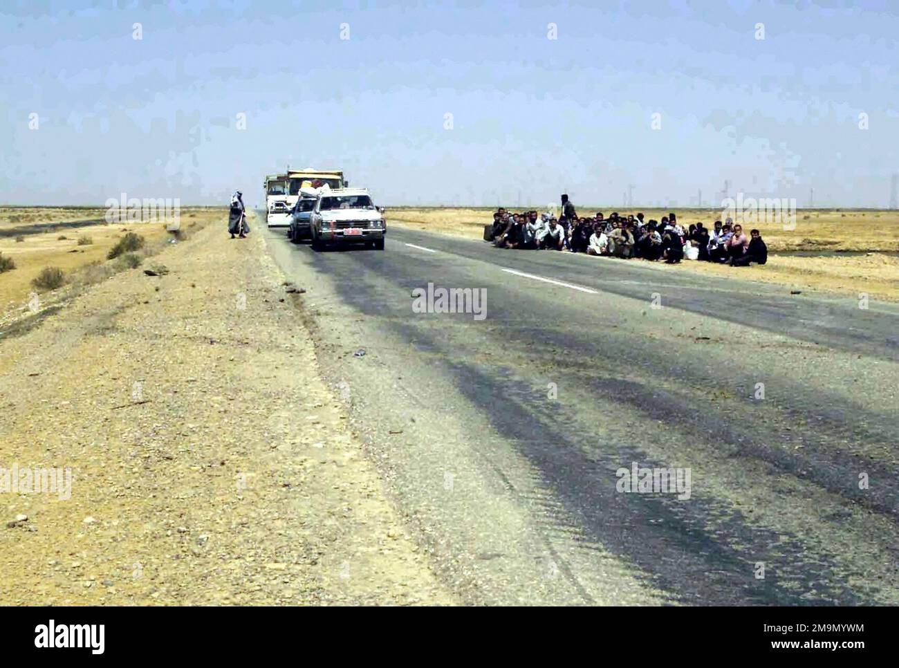 Iraqi civilians fleeing Baghdad on foot and in vehicles are stopped and detained temporarily for questioning outside of the town of Al Fay, by the 2nd Light Armored Reconnaissance Battalion, (LAR), Regimental Combat Team 1 (RCT1), in support of Operation IRAQI FREEDOM. (Substandard image). Subject Operation/Series: IRAQI FREEDOM Country: Iraq (IRQ) Stock Photo
