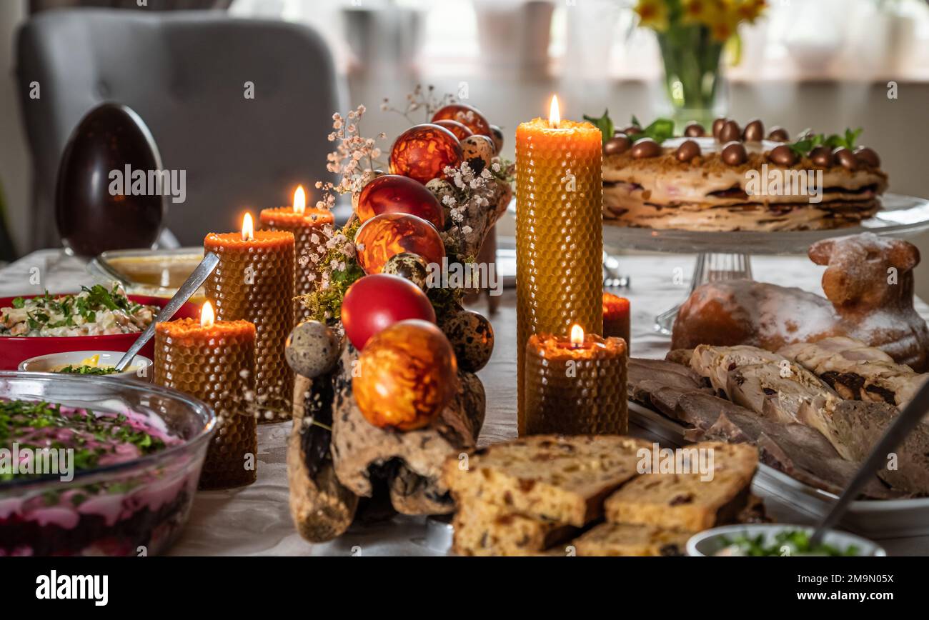 Easter feast with Easter eggs and candles on the festive table Stock Photo