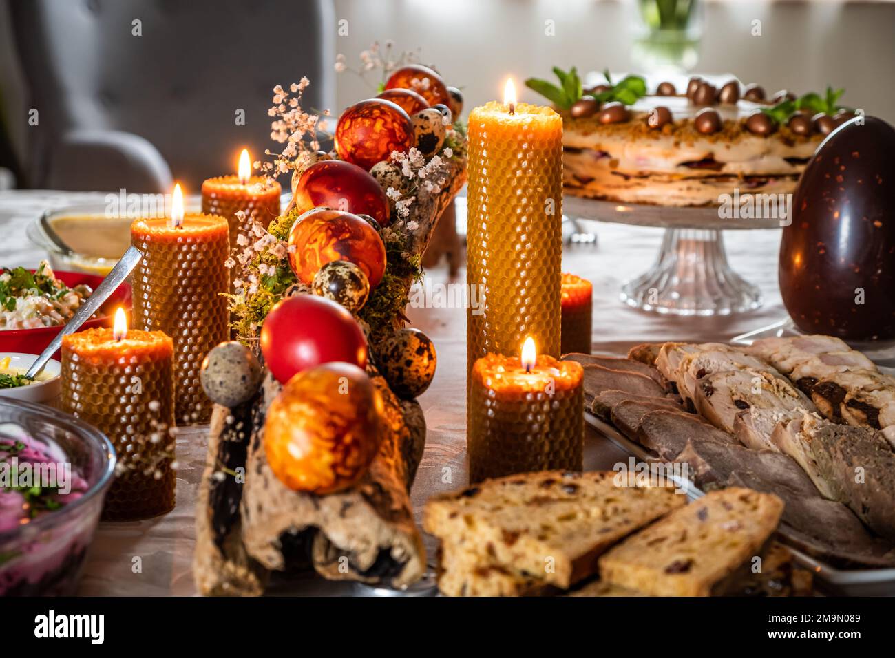 Easter feast with Easter eggs and candles on the festive table Stock Photo