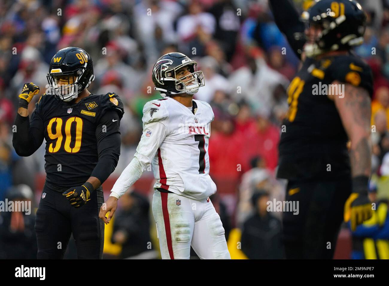 Reacting to interception thrown by Atlanta Falcons quarterback Marcus  Mariota (1) are Washington Commanders defensive end Montez Sweat (90) and  defensive tackle John Ridgeway (91) during the second half of an NFL