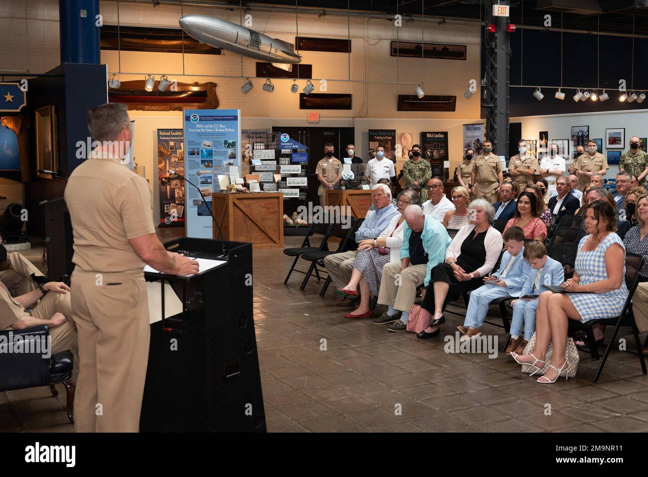 220520-N-DD694-1088 WASHINGTON (May 20, 2022) Senior Chief Musician Courtney Williams, left, addresses guests at his retirement ceremony.  Known as ‘The Voice of the Navy,’ and serving as the announcer for the past four presidential inaugurations, Williams retired after 26 years of service. Stock Photo