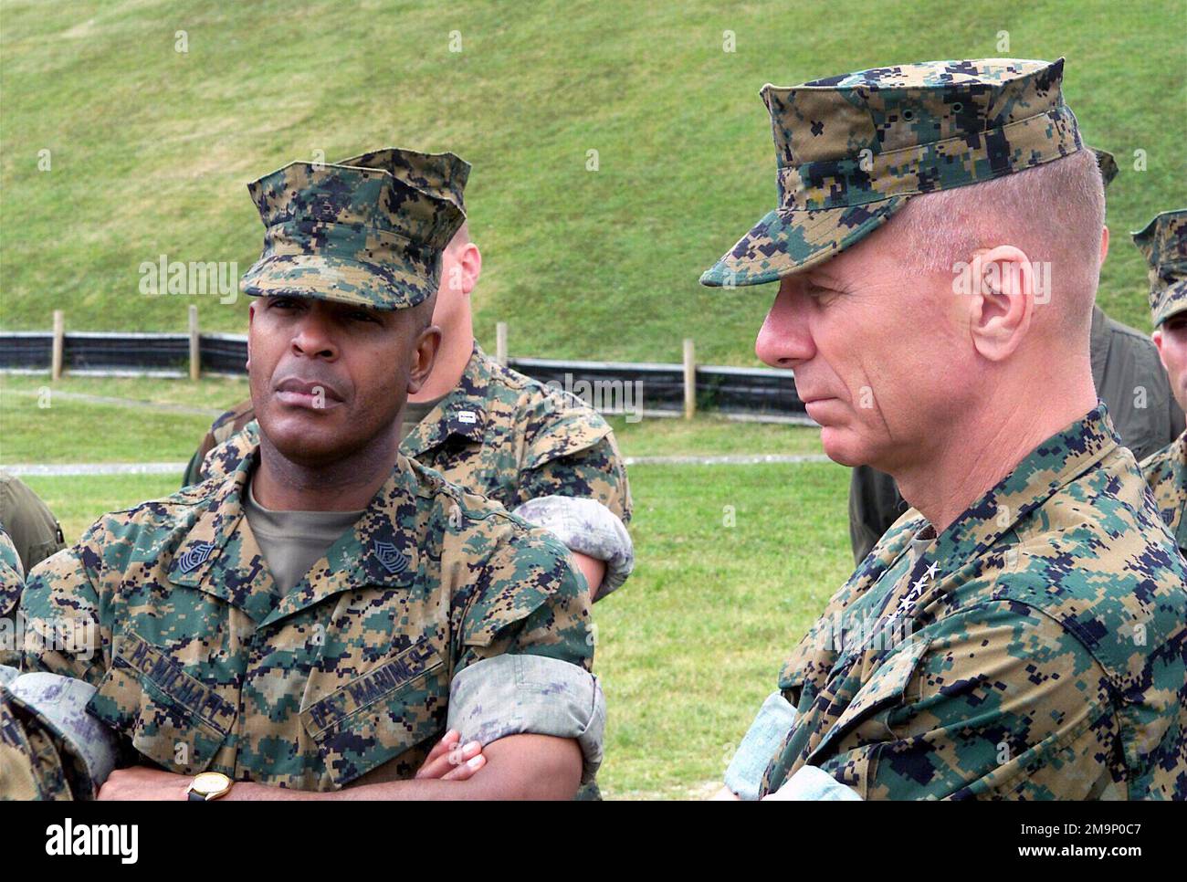 Sergeant Major of the Marine Corps Alford McMichael, (left), and General (GEN) Michael W. Hagee, (right), Commandant of the Marine Corps (CMC) listen to a briefing during a visit to range 10 at Fuel Pits LZ located on Camp Schwab, Okinawa, Japan. GEN Hagee visited III Marine Expeditionary Force (MEF) for the first time as the CMC. During his visit he will tour Marine bases located on Okinawa, Japan. Base: Camp Schwab Country: Japan (JPN) Scene Major Command Shown: HQMC Stock Photo