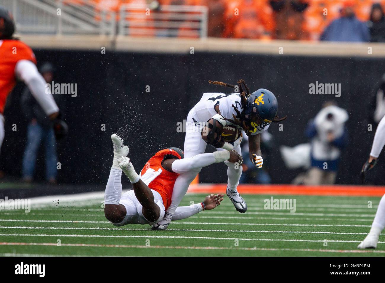 Oklahoma State linebacker Xavier Benson tackles West Virginia running