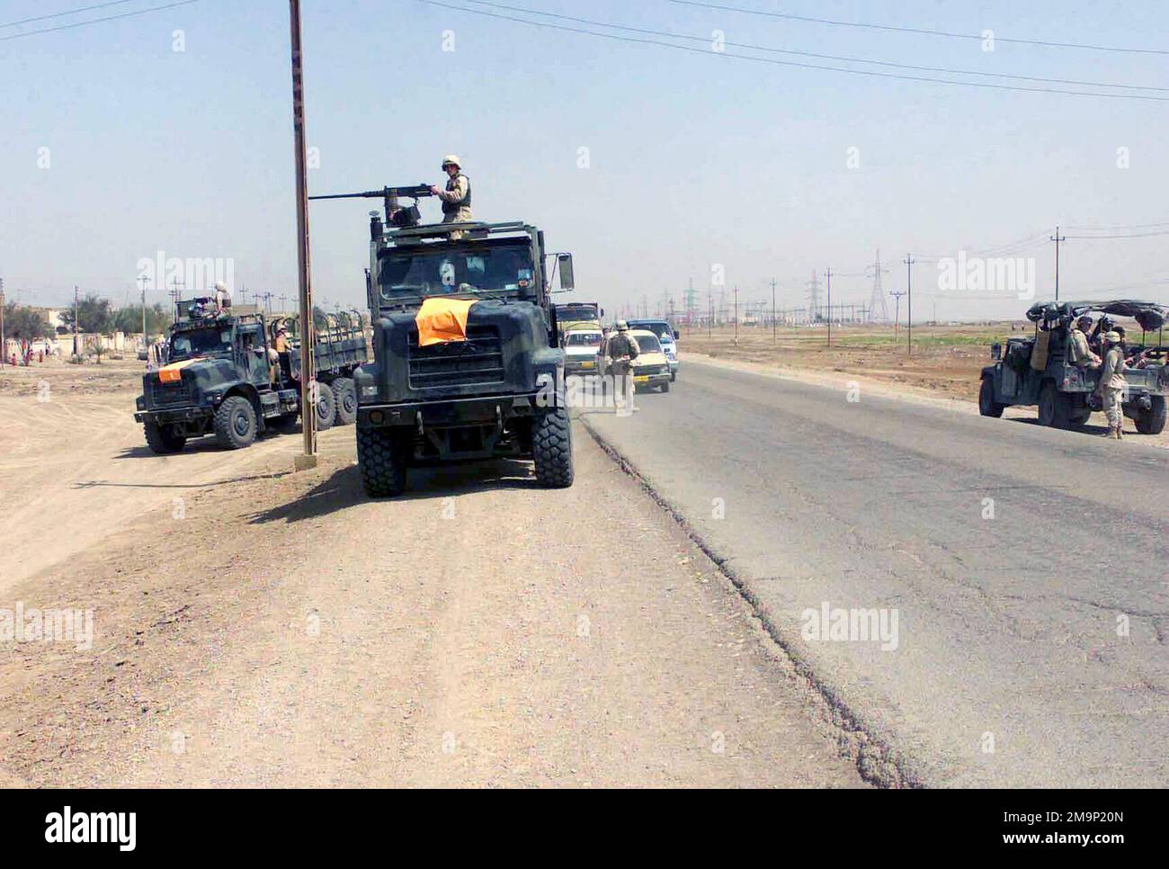 Two Medium Tactical Vehicle Replacement (MTVR) trucks, armed with M2HB ...