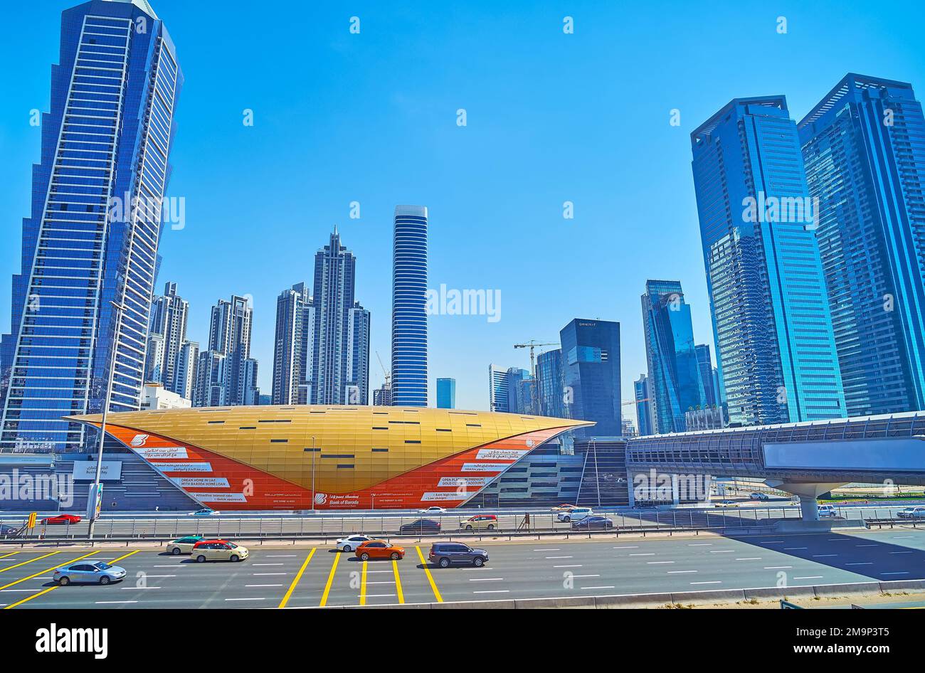 DUBAI, UAE - MARCH 6, 2020: Sheikh Zayed road with futuristic pavilion of Business Bay metro station, Al Batha Tower, Executive Towers, Bay Gate Tower Stock Photo
