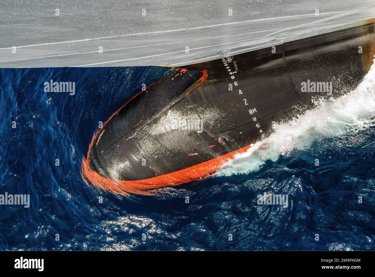 Aerial view of a ship's bulbous cutting through the water. Stock Photo