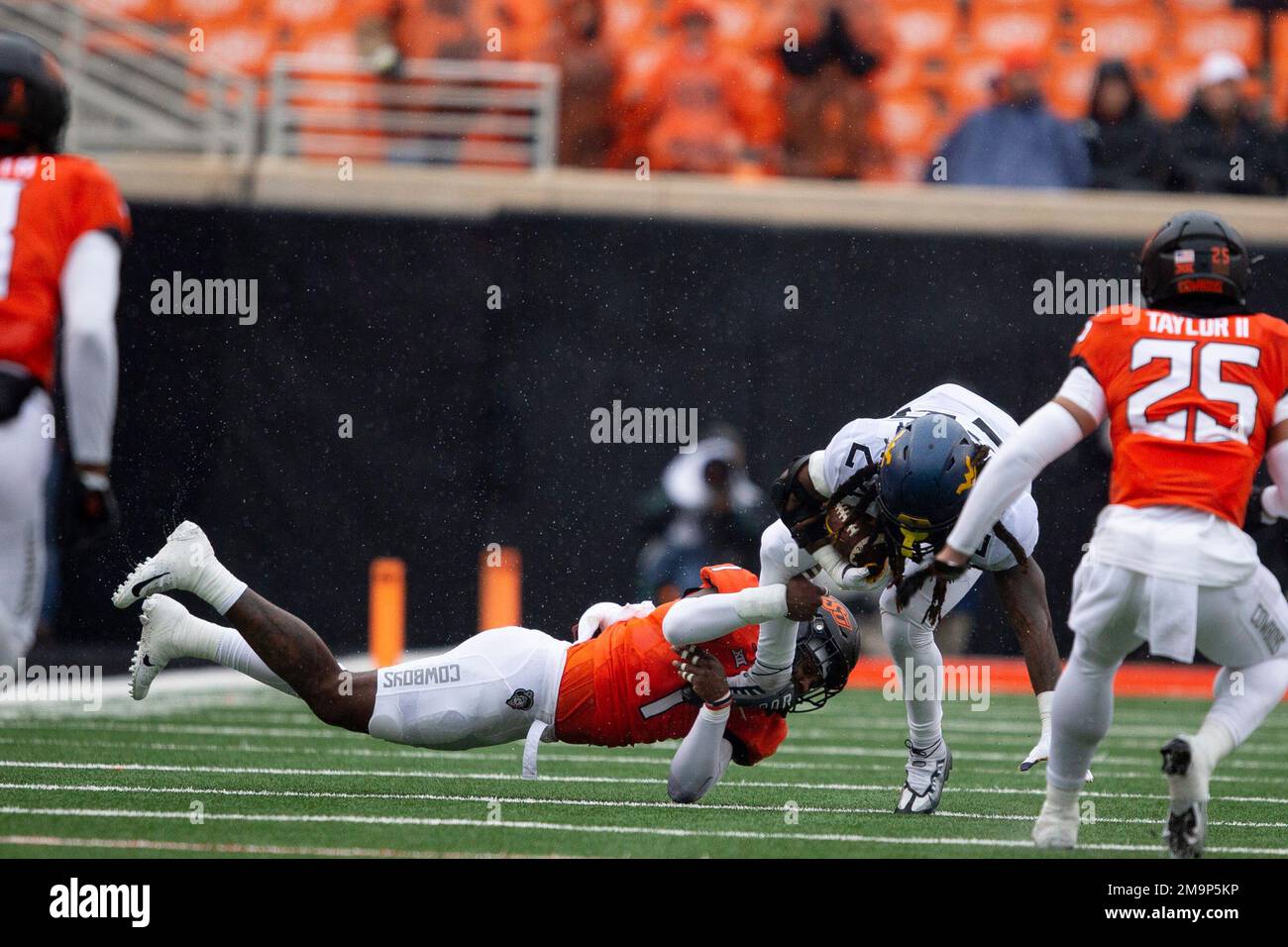 Oklahoma State linebacker Xavier Benson tackles West Virginia running
