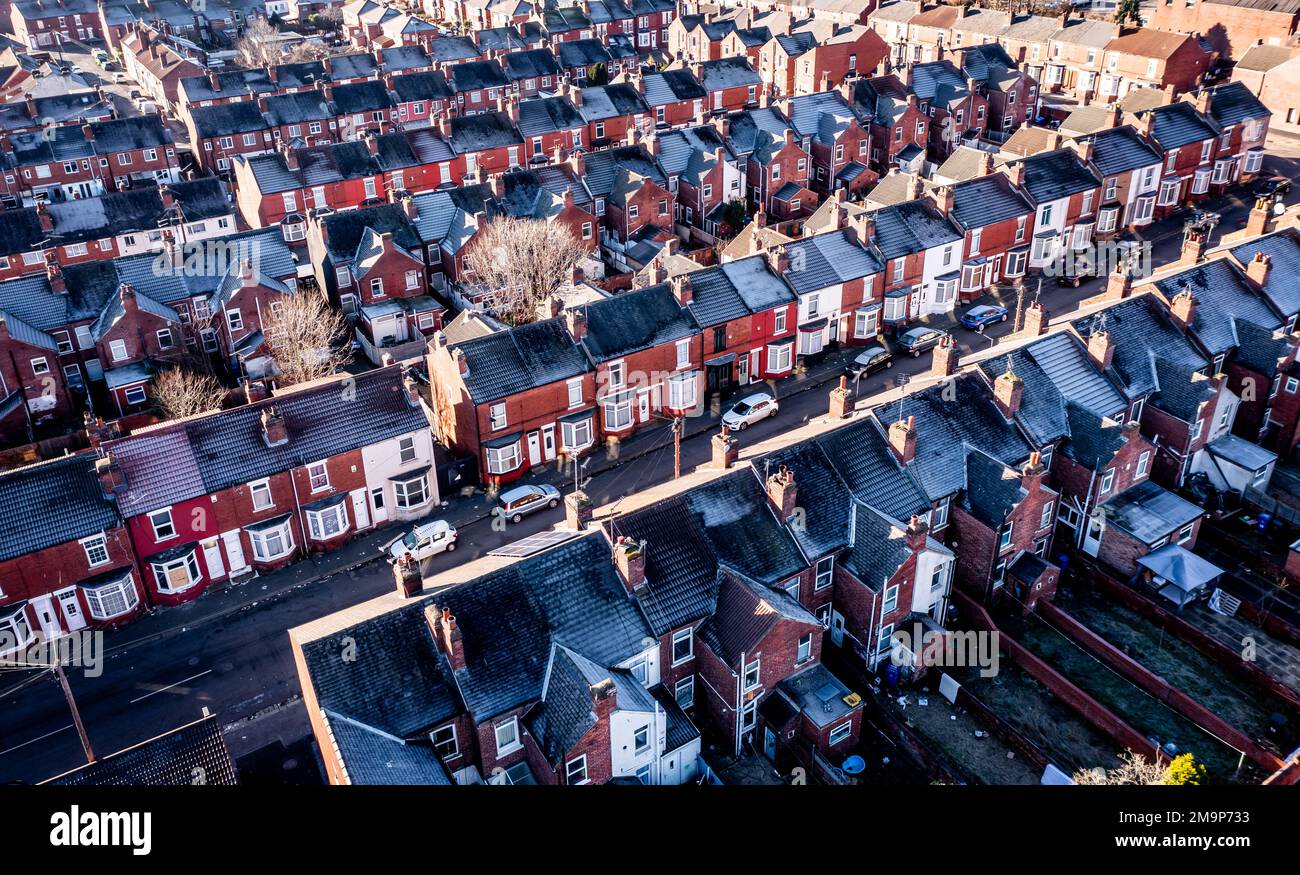 Aerial view of a row of terraced or back to back working class houses during the Winter months with frost on rooftops during the energy and cost of li Stock Photo