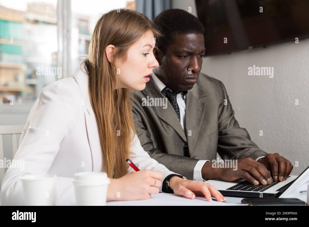 Focused coworkers working together Stock Photo - Alamy