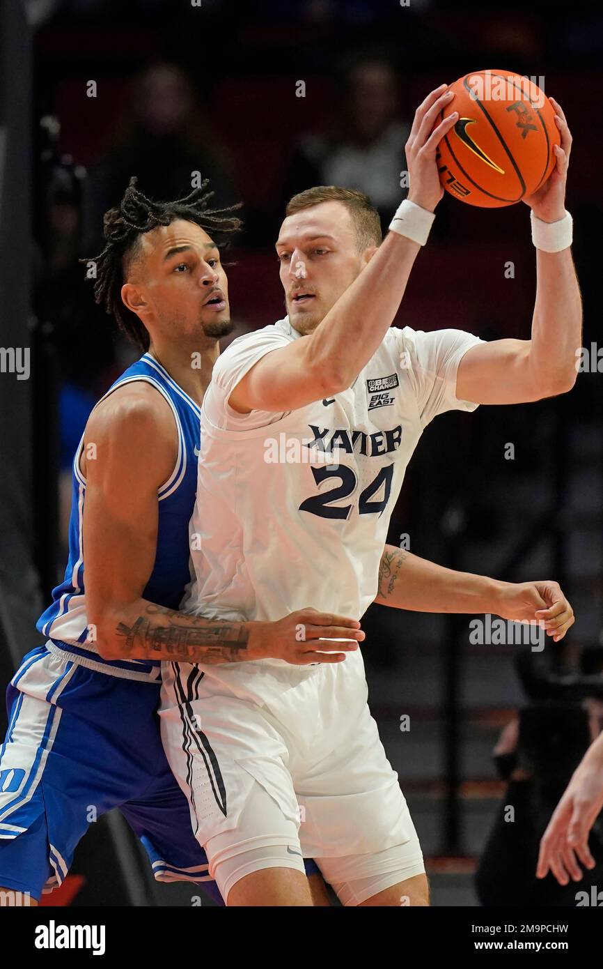 Duke center Dereck Lively II, left, guards Xavier forward Jack Nunge