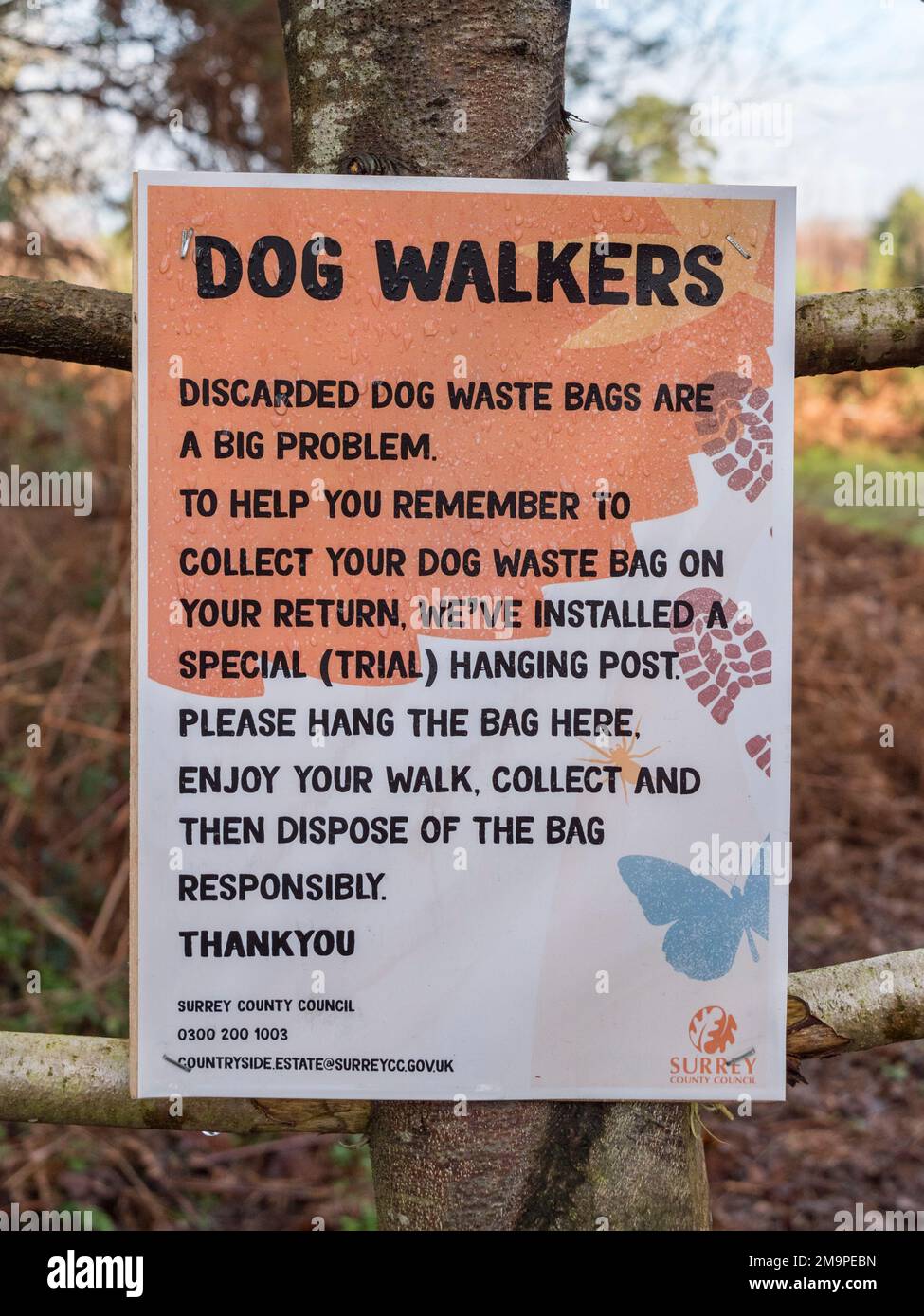 Sign on a dog waste 'tree' hanging post near the main car park to Wisley Common, Woking, Surrey, UK. Stock Photo