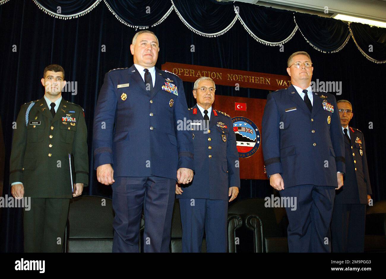 030501-F-7418E-001. [Complete] Scene Caption: US Air Force (USAF) and Turkish Air Force members of Combined Task Force Operation NORTHERN WATCH (ONW) stand at attention during a Deactivation Ceremony held at Incirlik Air Base, (AB) Turkey. The ceremony signifies the successful end to its mission of enforcing the United Nations Security Council Resolutions charged with enforcing the no-fly zone north of the 36th parallel in Iraq and monitoring Iraqi compliance to the resolutions. Pictured left-to-right are: US Army (USA) First Lieutenant (1LT) Eric Rodino, Combined Task Force CHIEF-of-STAFF Exe Stock Photo