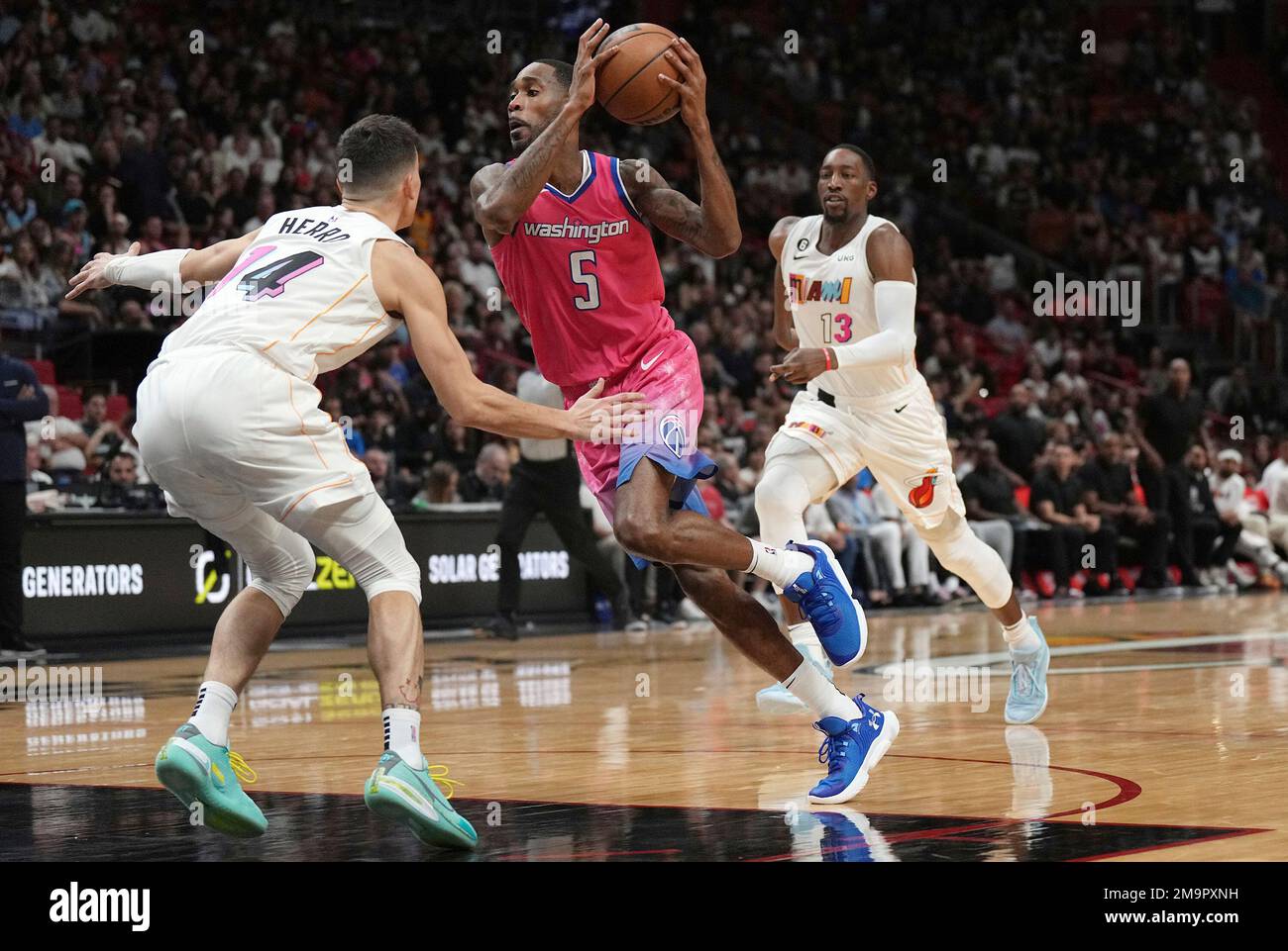 Washington Wizards forward Will Barton (5) drives to the basket as Miami  Heat guard Tyler Herro (14) defends during the second half of an NBA  basketball game Wednesday, Nov. 23, 2022, in