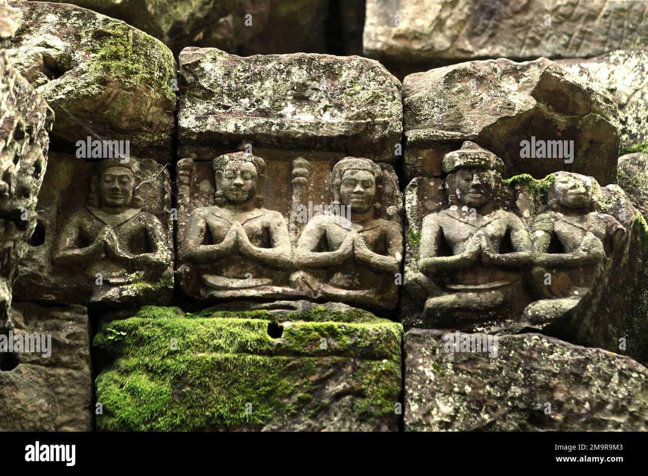 Reliefs of seated man in meditative posture, at Preah Khan temple in Siem Reap, Cambodia. Stock Photo