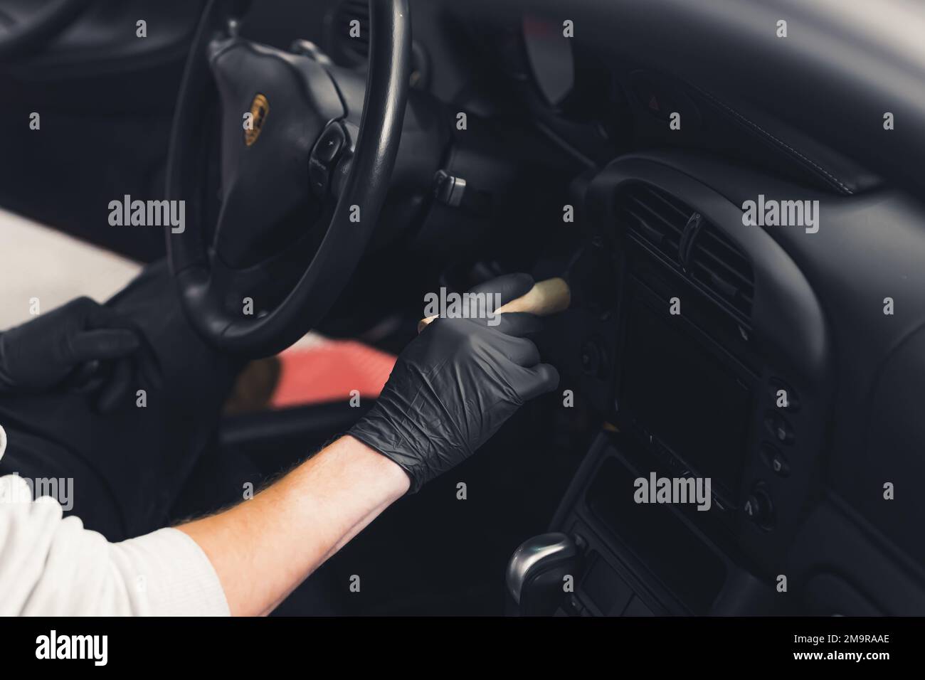 Car detailing professionalism cleaning the inside of sports car with a