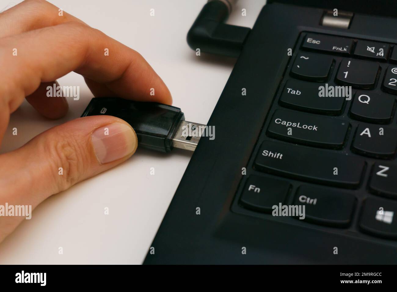 person plug in usb drive into laptop port Stock Photo