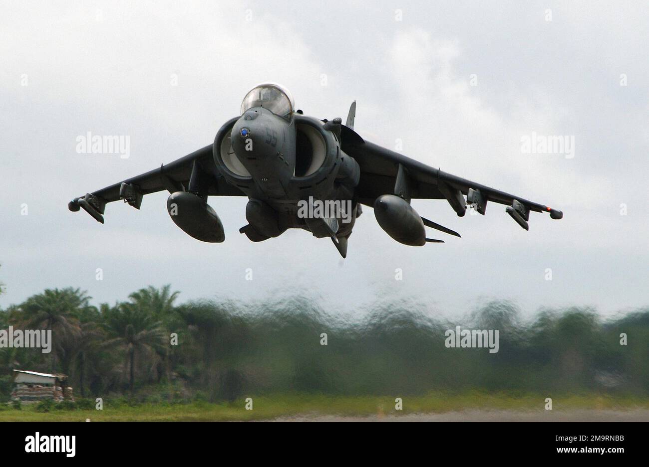 A US Marine Corp (USMC) AV-8B Harrier aircraft, deployed with the 398th Air Expeditionary Group (AEG), takes off at Freetown International Airport, Sierra Leone. The 398th AEG is currently in Sierra Leone to provide personnel recovery and emergency evacuation capability for the Humanitarian Assistance Survey Teams (HAST) and the Fleet Anti-terrorism Security Teams (FAST) in Liberia, during Joint Task Force (JTF) Liberia. Subject Operation/Series: JTF LIBERIA Base: Freetown International Airport Country: Sierra Leone (SLE) Stock Photo