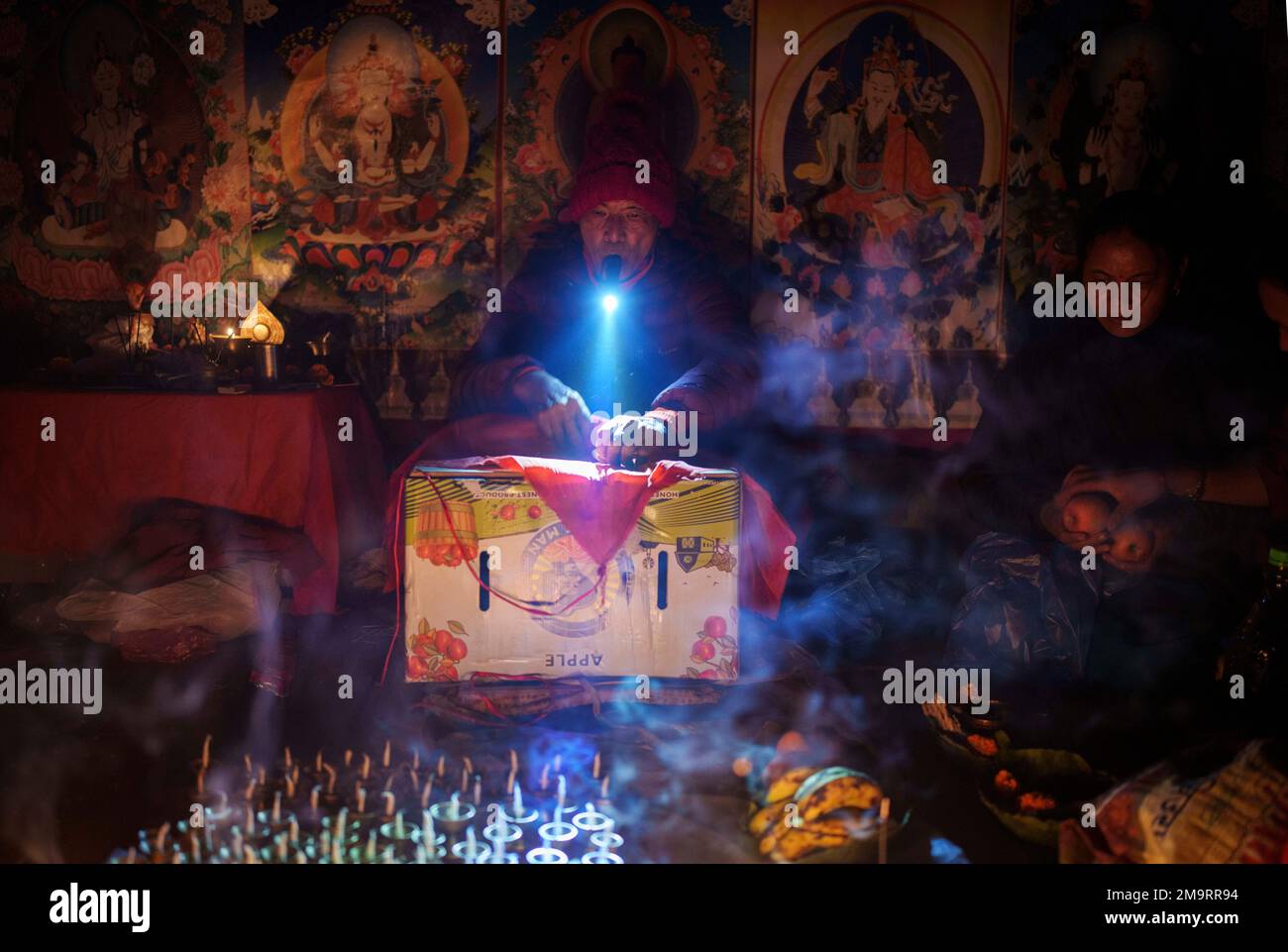 A Buddhist monk performs rituals holding torch light on his mouth