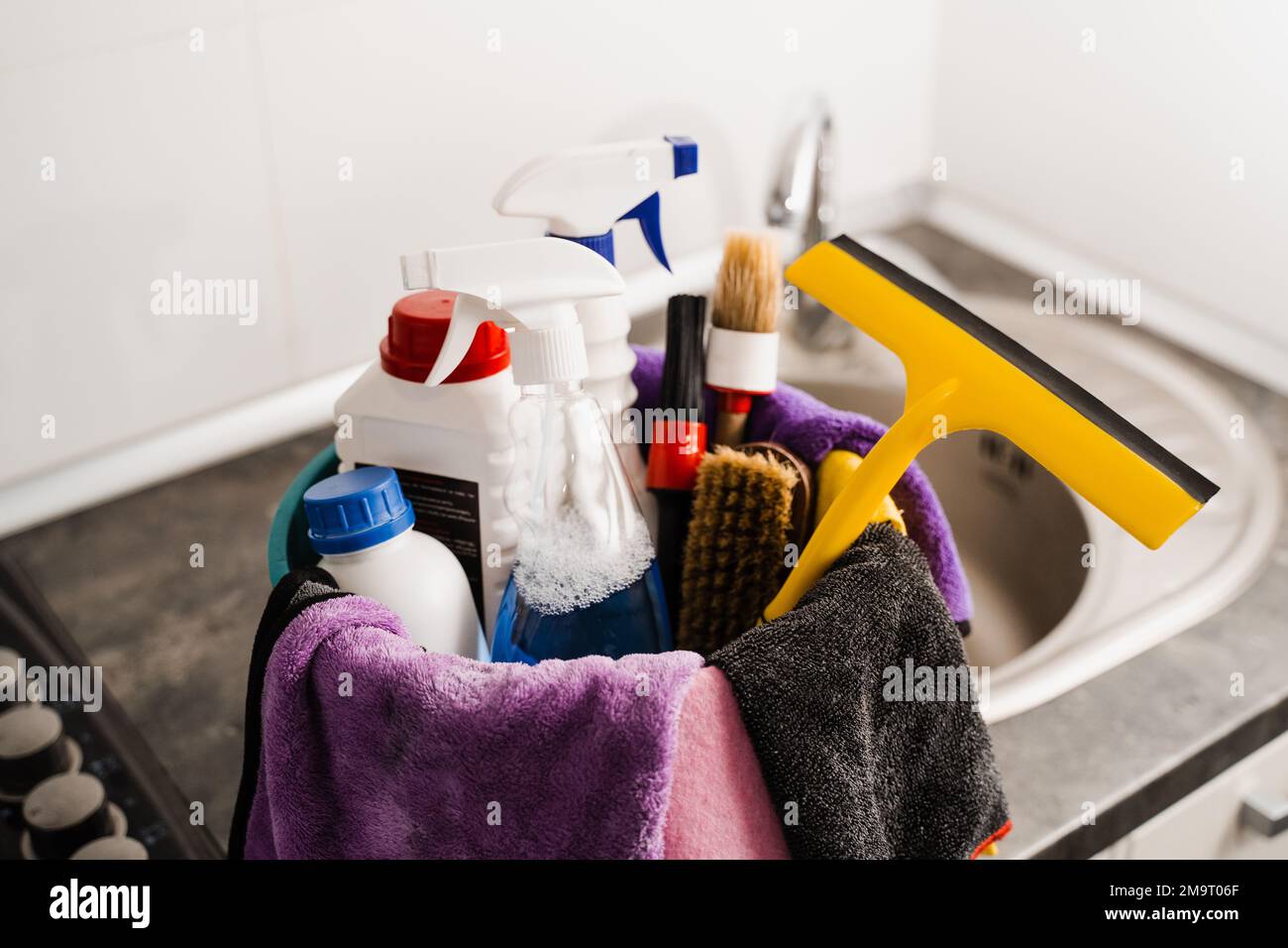 Close-up bucket with detergent and microfiber rags for house cleaning ...