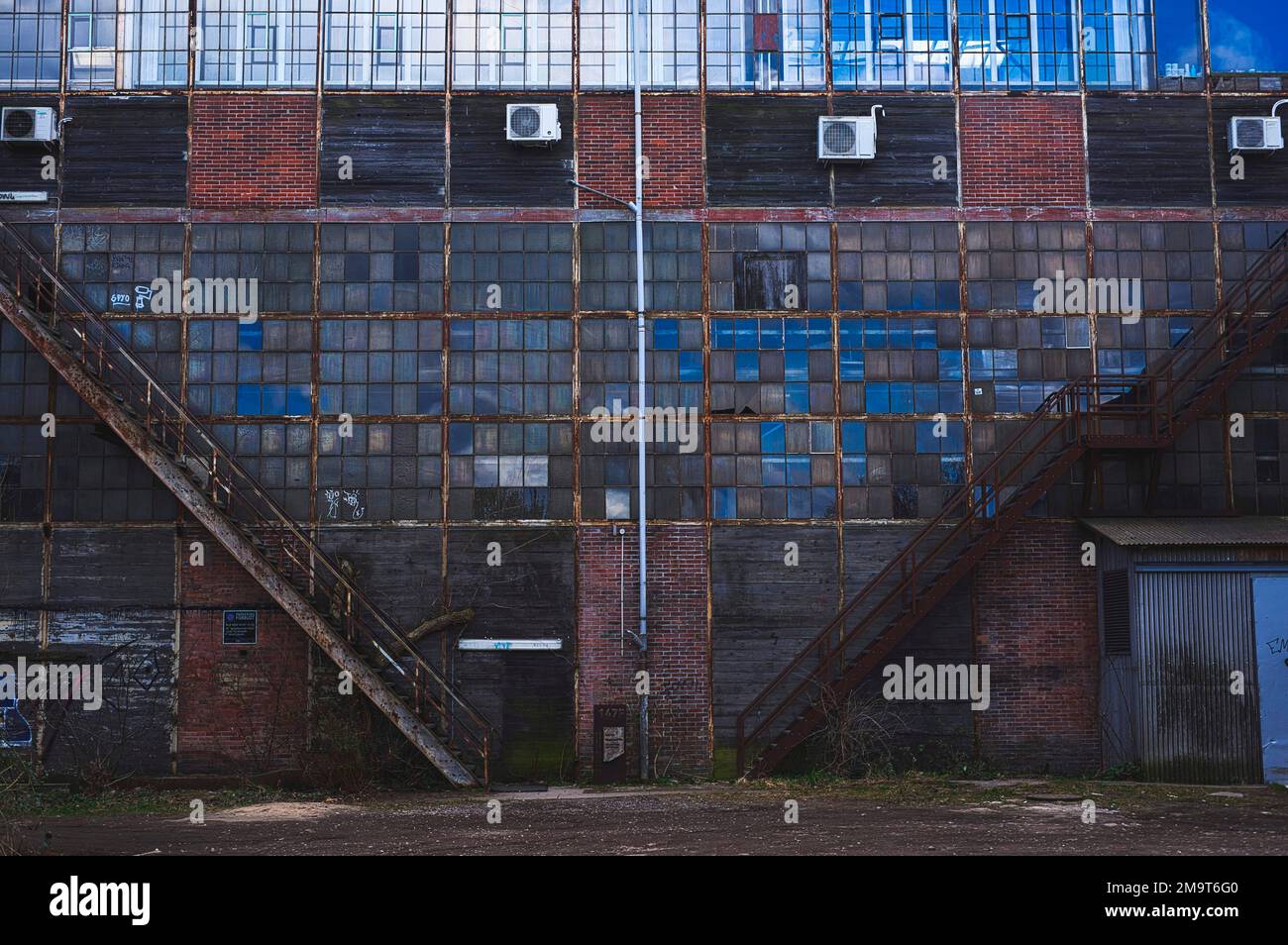 A view of an old industrial storage building with small windows Stock ...