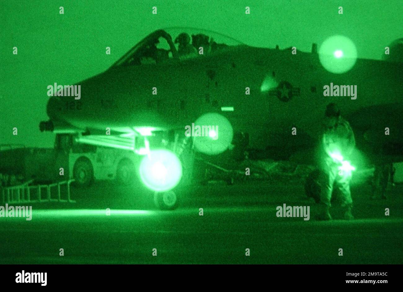 A US Air Force (USAF) A-10 Thunderbolt II ground crew, 303rd Fighter Squadron (FS), Whiteman Air Force Base, Missouri (MO), perform preflight checks on its jet prior to a nighttime take off at Kirkuk Air Base (AB) in northern Iraq. The fighter squadron is responsible for providing close air support (CAS) to ground troops throughout the northern third of the country in support of Operation IRAQI FREEDOM. Base: Kirkuk Air Base Country: Iraq (IRQ) Stock Photo