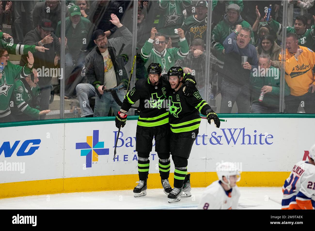 Fans cheer as Dallas left wing Benn (14) and center Tyler Seguin (91) celebrate after Benn's goal in the third period of an NHL hockey game against New York