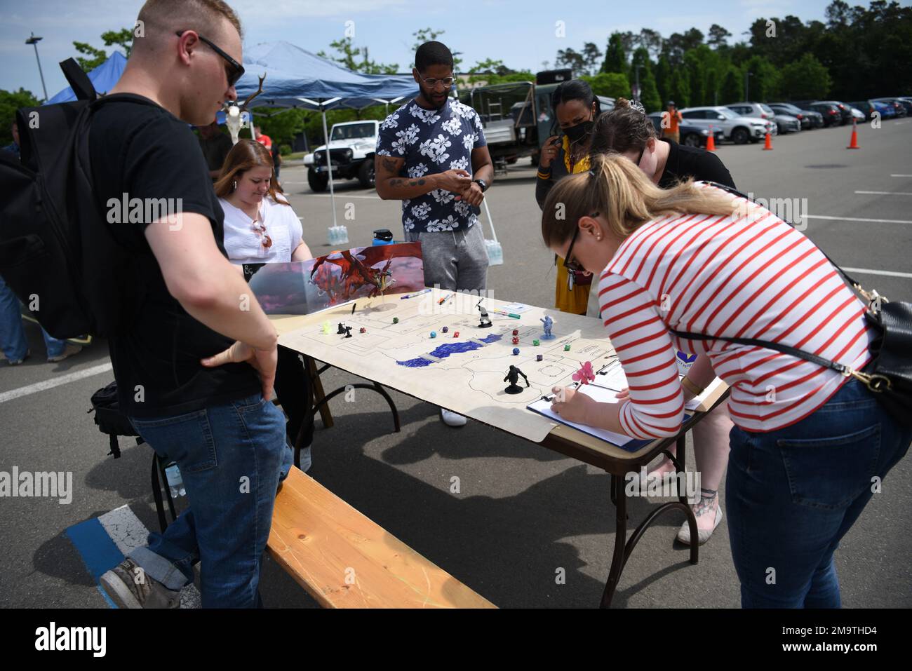 Military members of the Kaiserslautern Military Community sign up for the Dungeons and Dragons club on Ramstein Air Base, Germany, May 20, 2022, at the KMC In Da Club connections event. Organizers created the event to reinvigorate and reestablish human connections following the loneliness of the COVID-19 pandemic. Attendees learned more about various clubs within the KMC. Stock Photo